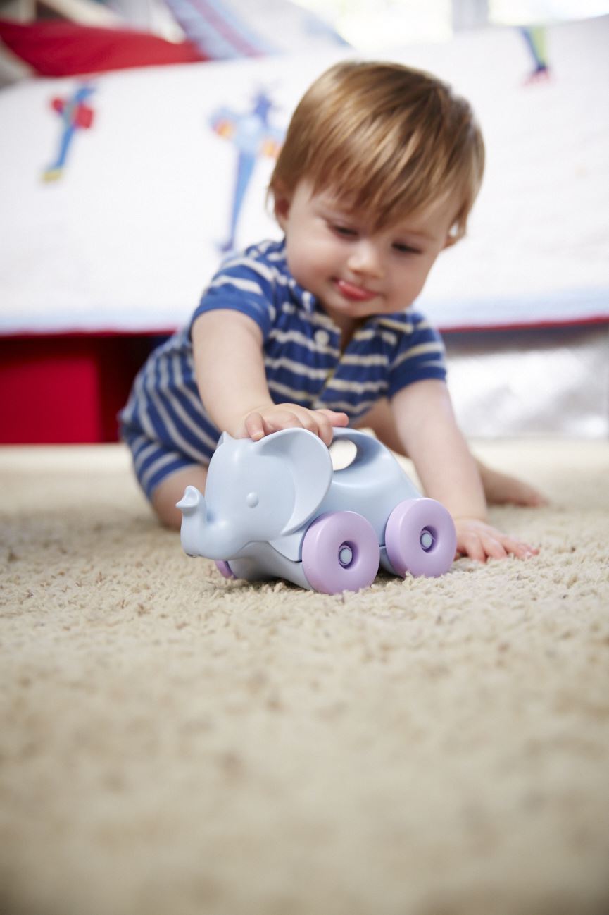 Baby playing with Elephant-on-wheels from the Baby Toy Starter Set