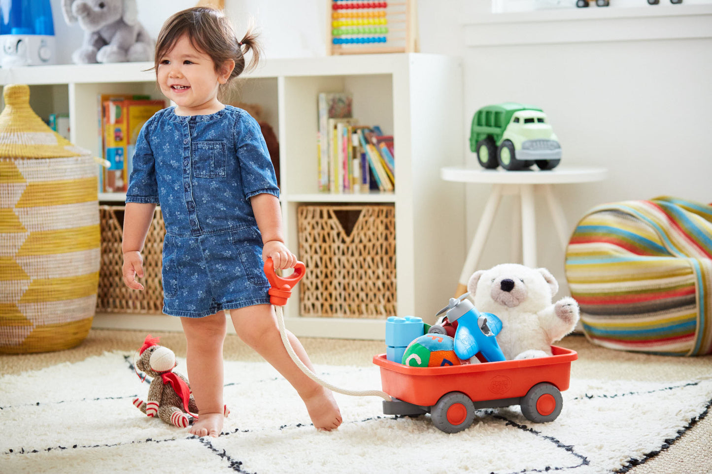 Girl playing with Orange Wagon