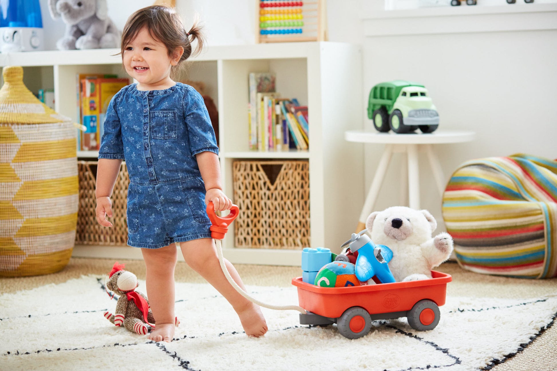 Girl playing with Orange Wagon