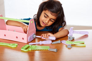 Girl playing with Pink Tool Set