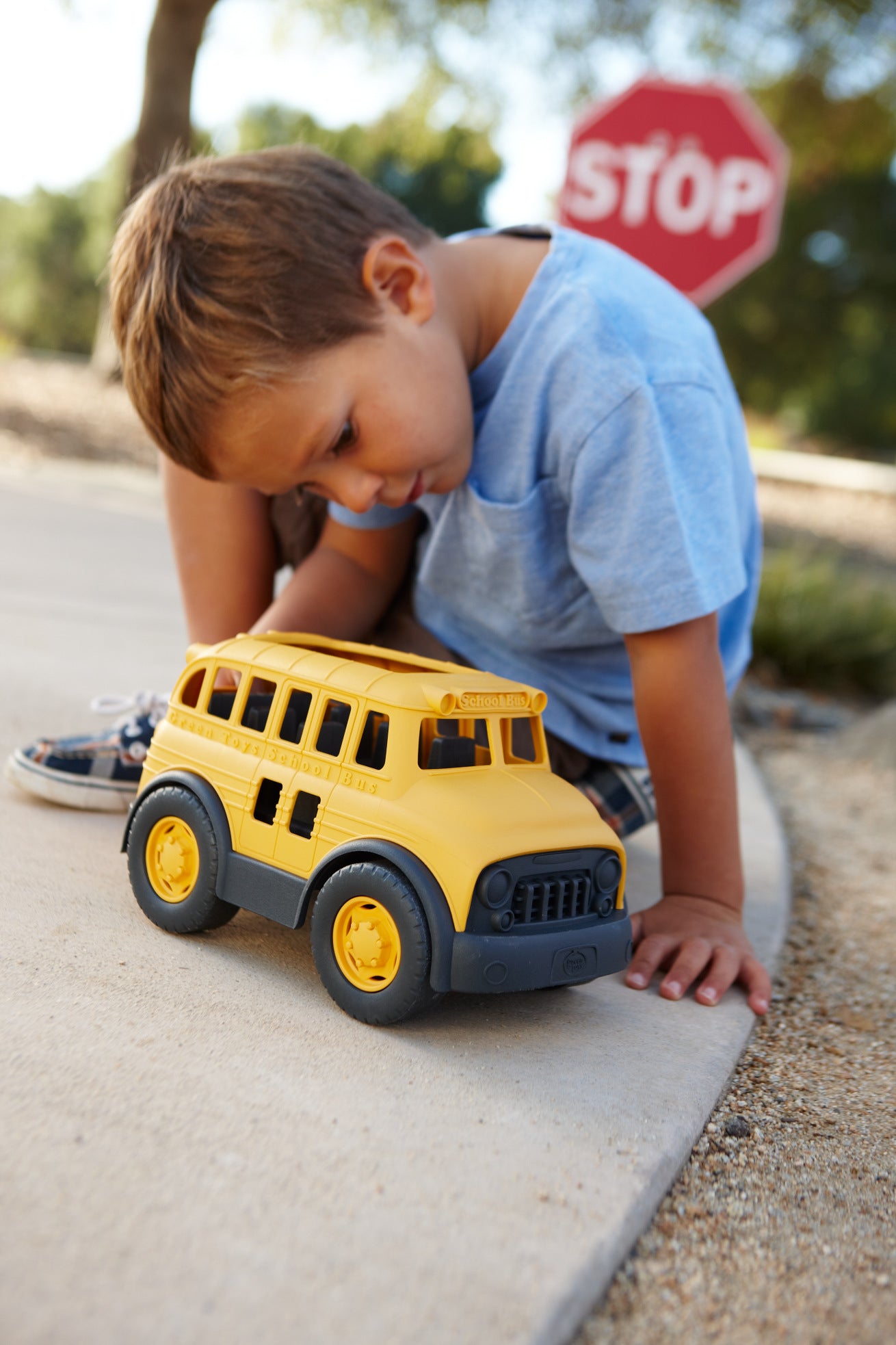Boy playing with School Bus