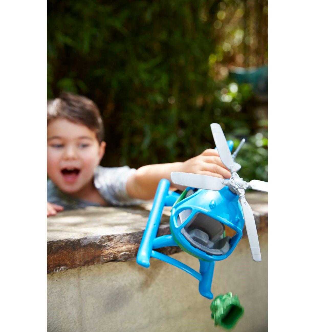 Boy playing with Blue Top Helicopter