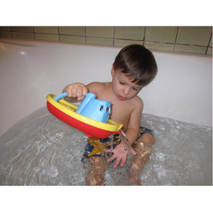 Boy in bath with Blue Tug Boat