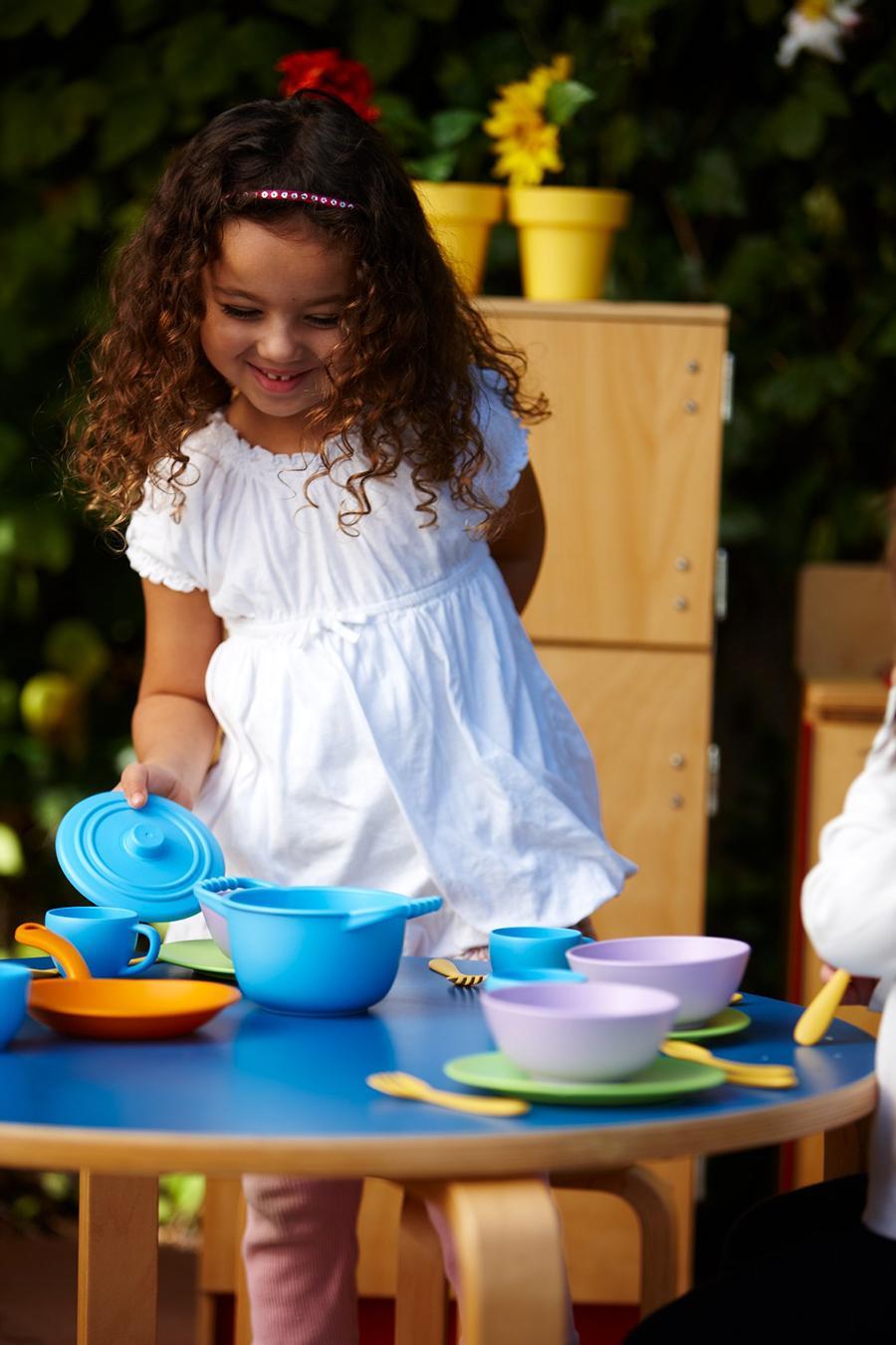 Girl playing with Cookware and Dining Set