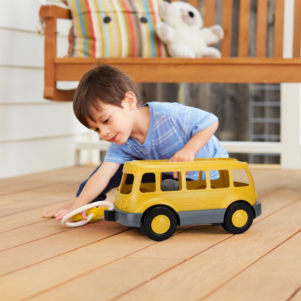 Boy playing with School Bus Wagon