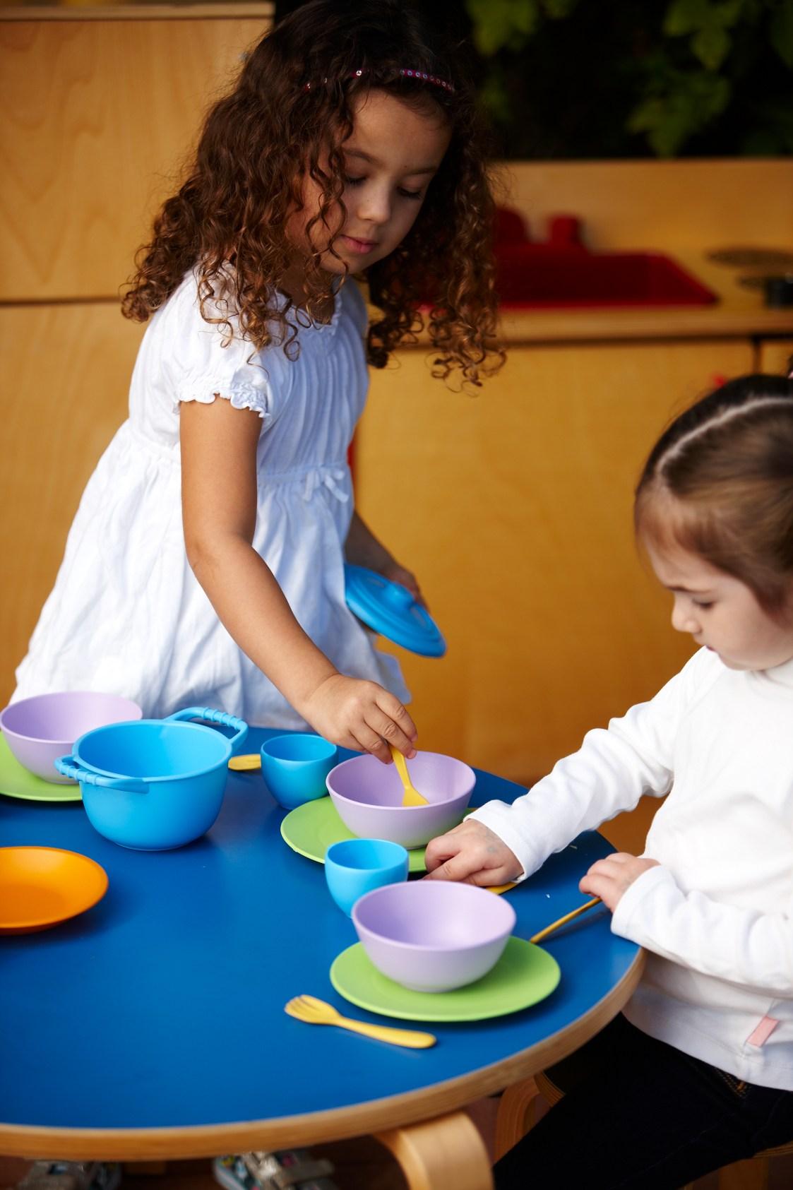 Girls playing with Cookware and Dining Set