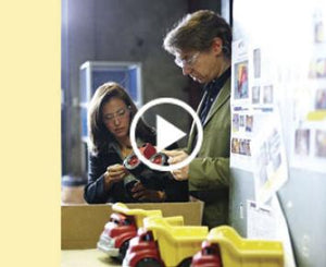 Still of two people inspecting toys