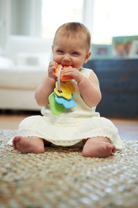 Baby girl chewing on First Keys