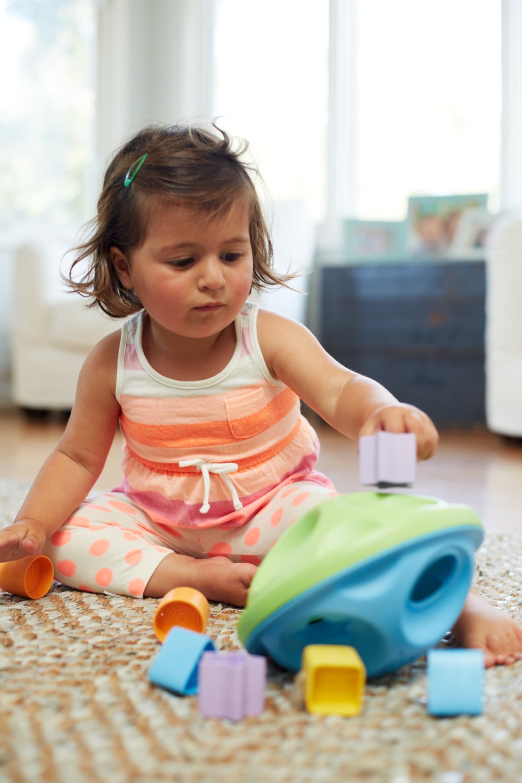 Girl playing with Shape Sorter