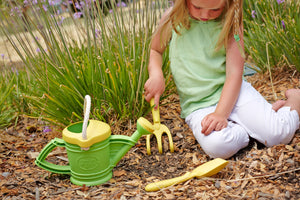 Girl playing with Rake from Watering Can set