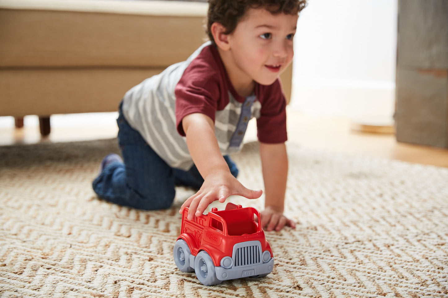 Boy playing with Fire Engine