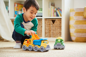 Boy playing with Construction Trucks
