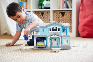 Boy playing with House Playset