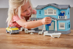 Girl playing with House Playset