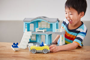Boy playing with House Playset