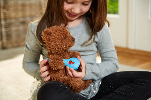 Girl playing with thermometer from Doctor's Kit