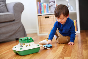 Boy on floor playing with Ferry Boat
