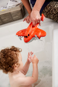 Child in bath with mom playing with Fire Plane (Supports Fire Relief)