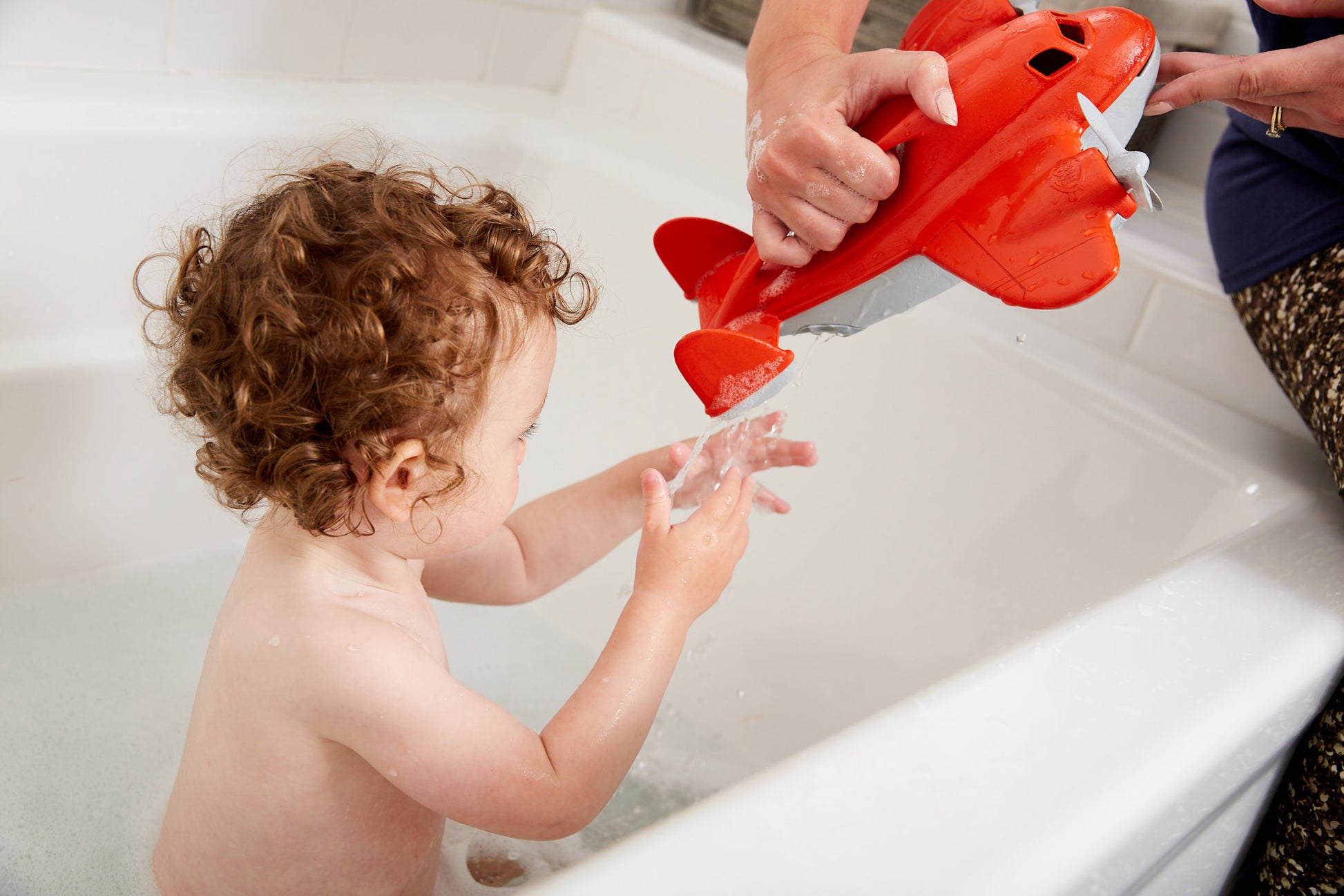 Child in bath with mom playing with Fire Plane (Supports Fire Relief)