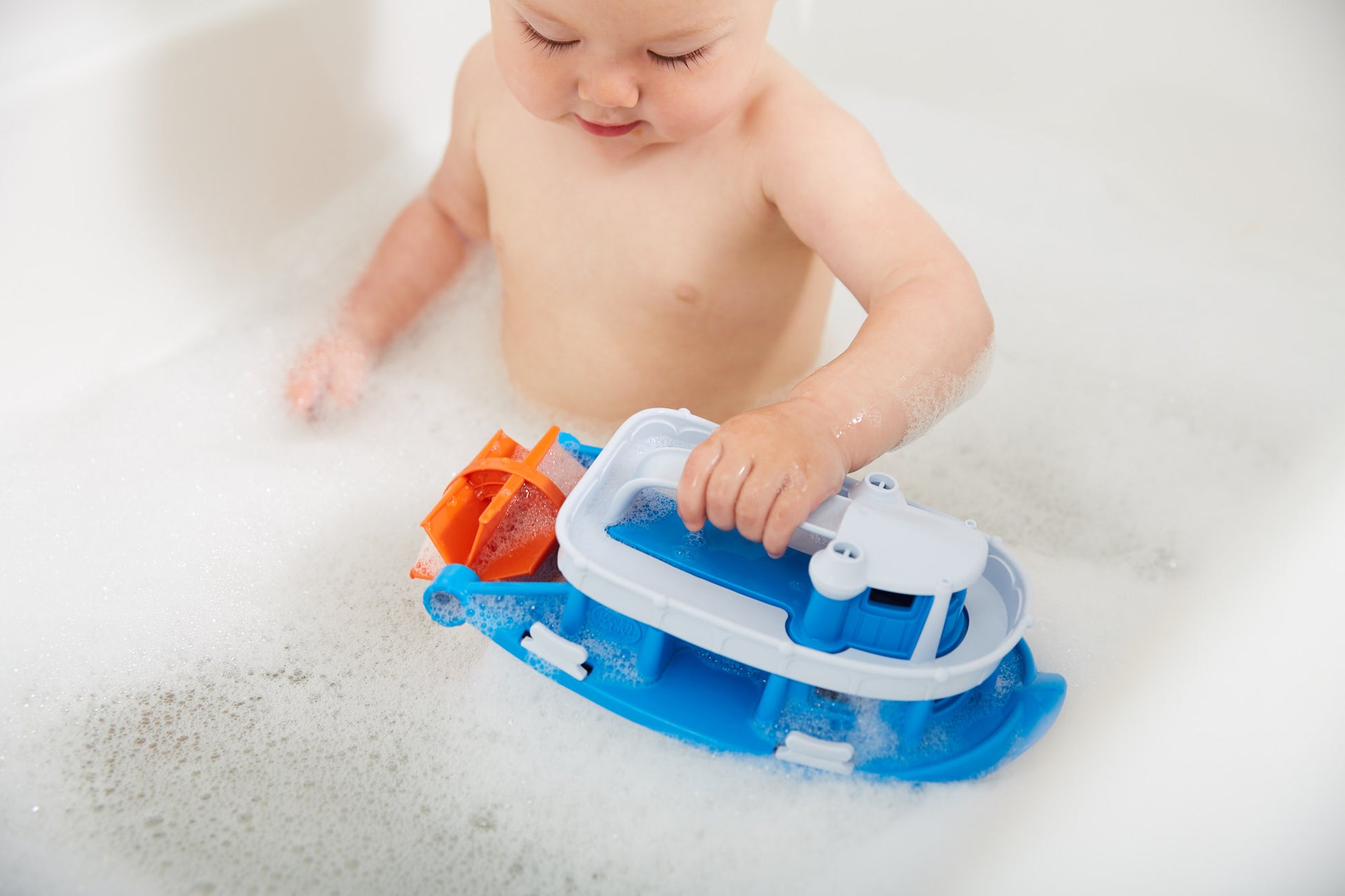 Child in bath playing with Paddle Boat