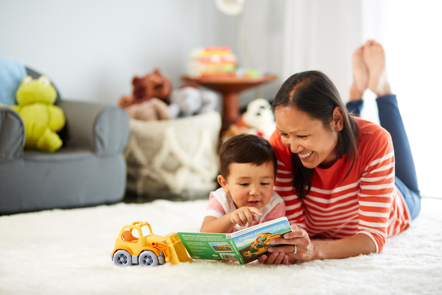 Child and mom reading Puppy Construction Crew Board Book