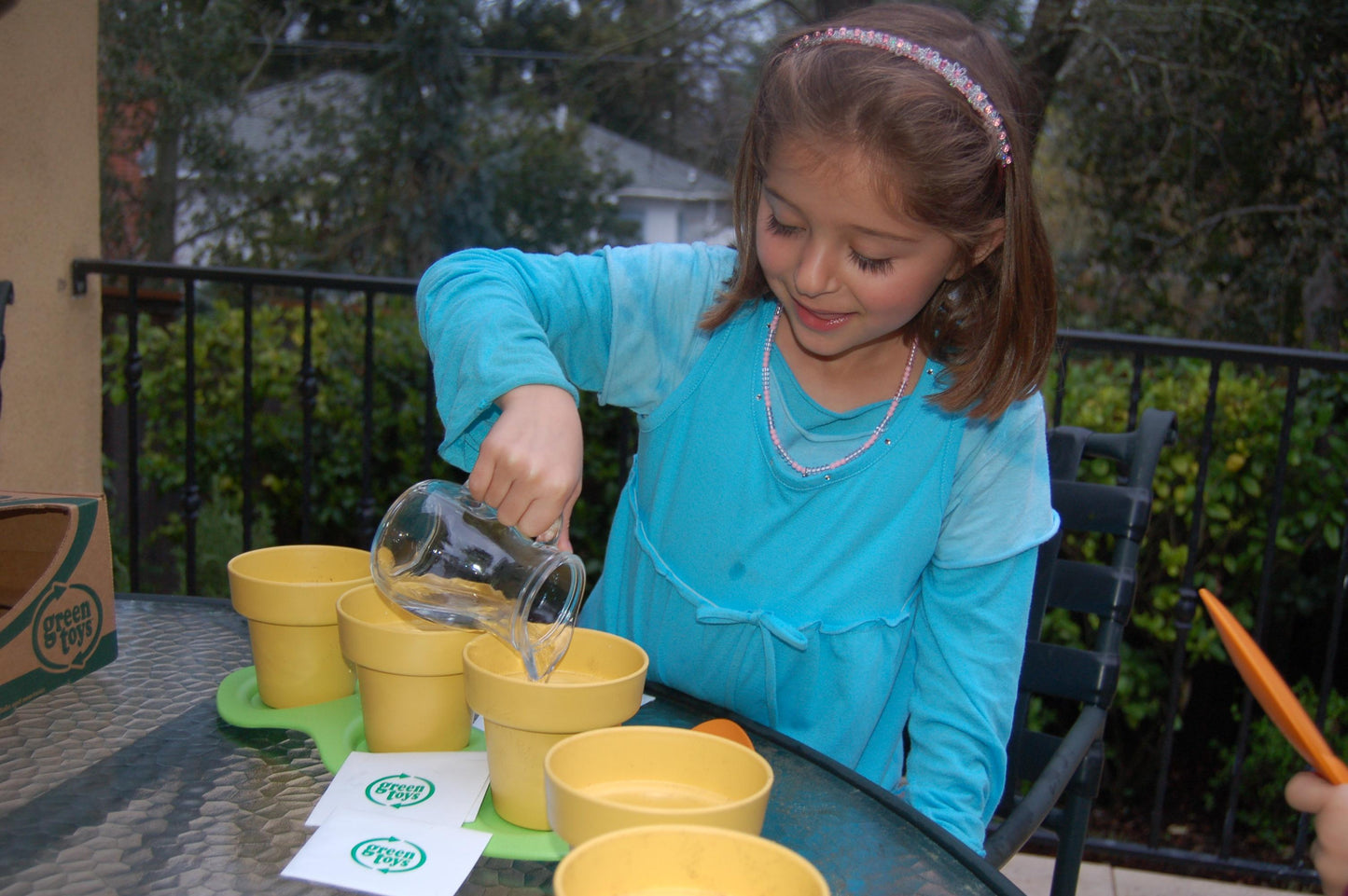Girl adding water to Indoor Gardening Kit