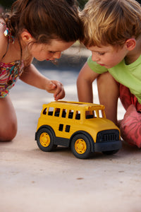 Girl and boy playing with School Bus
