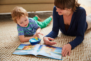 Child and caregiver reading Boats Build for Speed Storybook