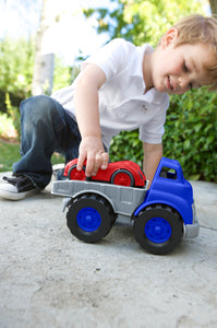 Boy playing with Flatbed Truck & Race Car