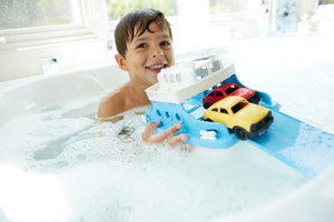 Boy in bath playing with Ferry Boat