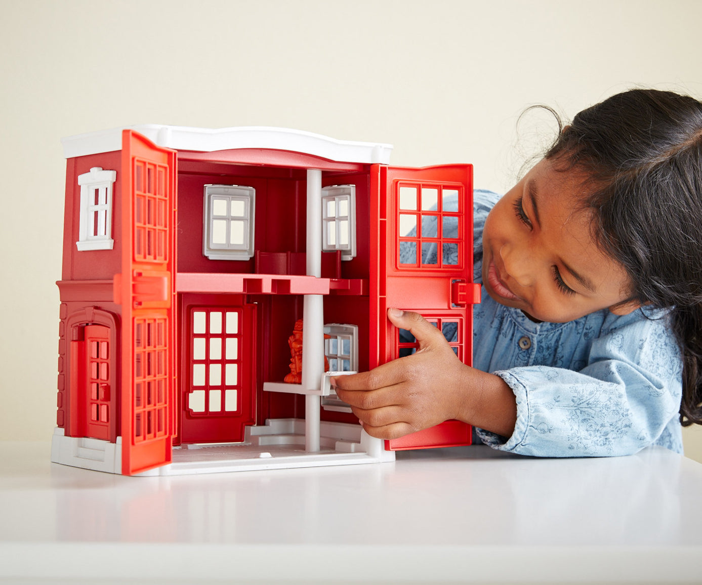 Girl playing with Fire Station Playset