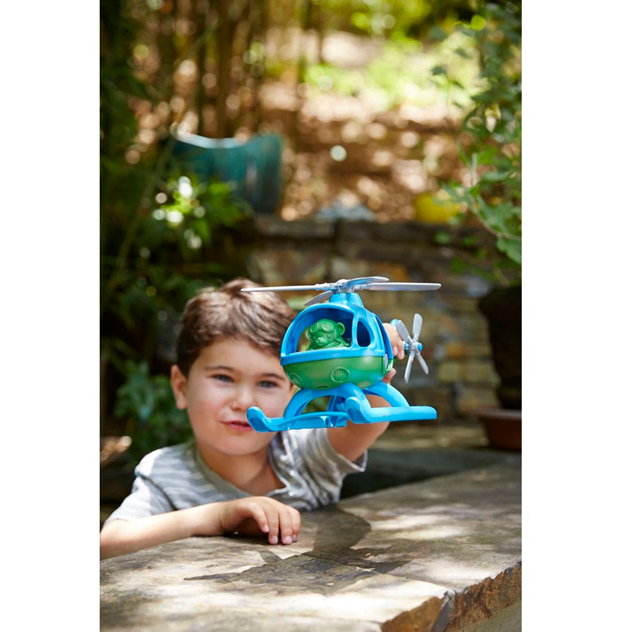 Boy playing with Blue Top Helicopter