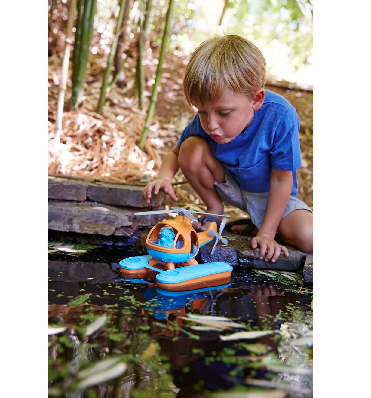 Boy playing with Orange Top Seacopter in water