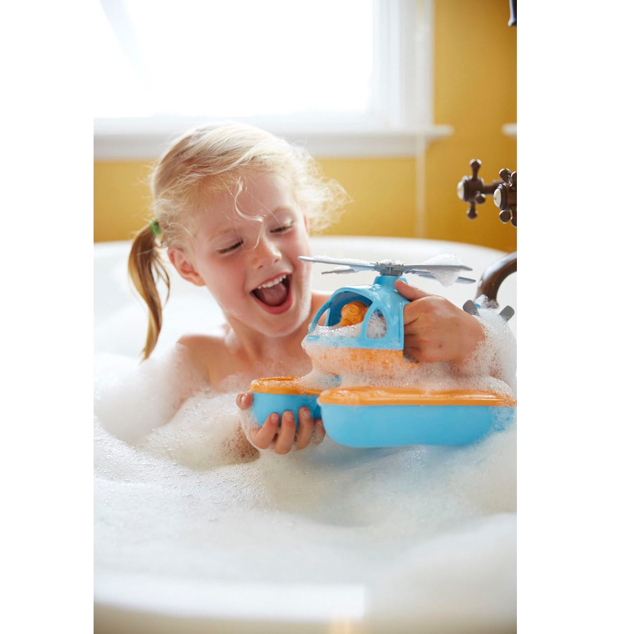 Girl in bath playing with Blue Top Seacopter