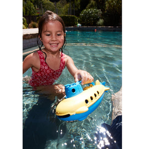 Girl in pool playing with Blue Submarine