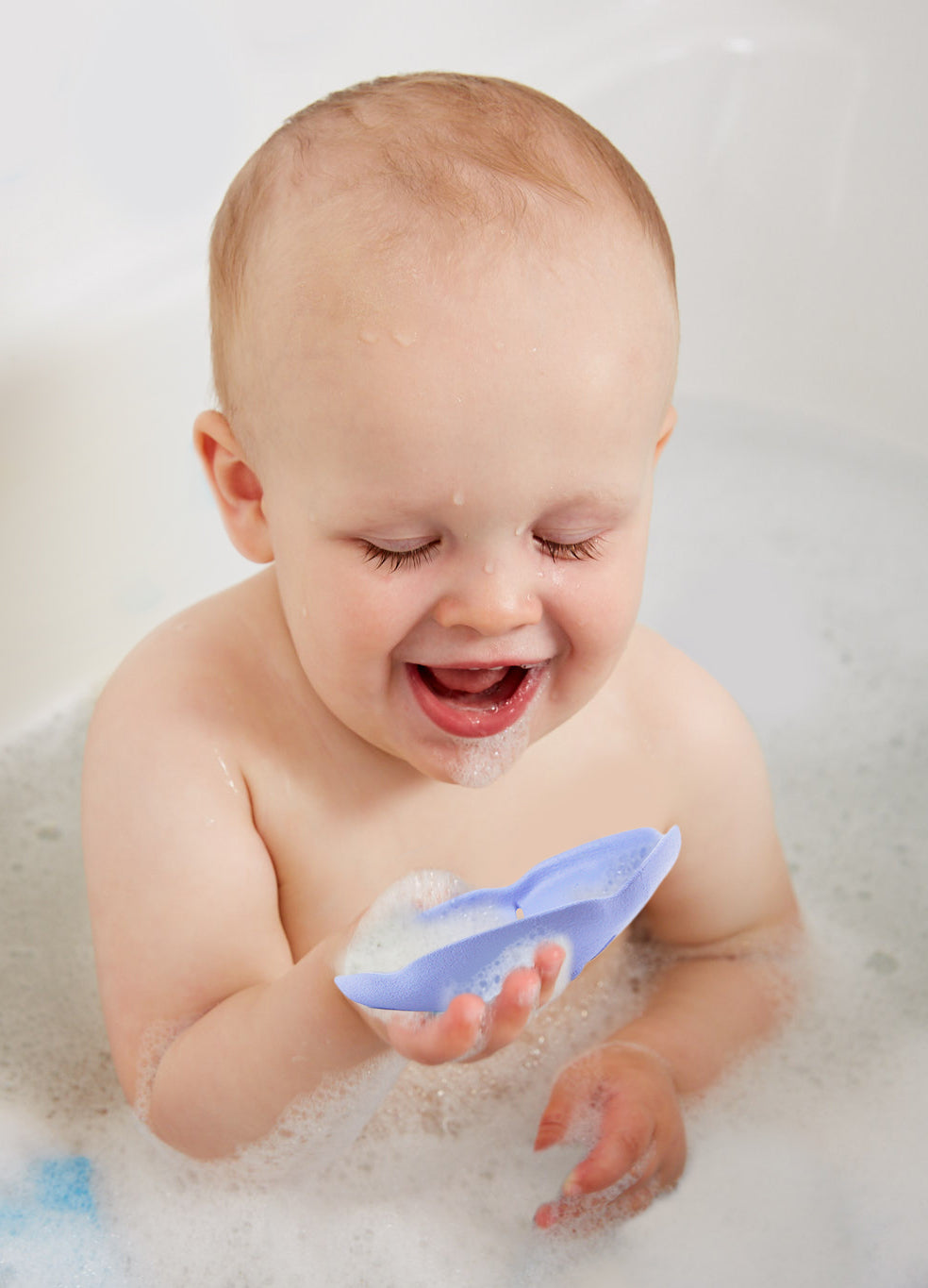 Baby in bath playing with Sea Life Set