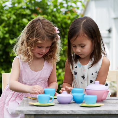 Two girls playing with Tea Set