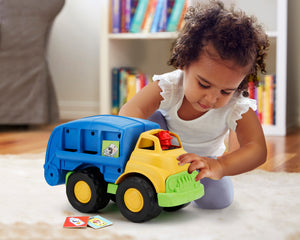 Girl playing with Mickey Mouse Recycling Truck