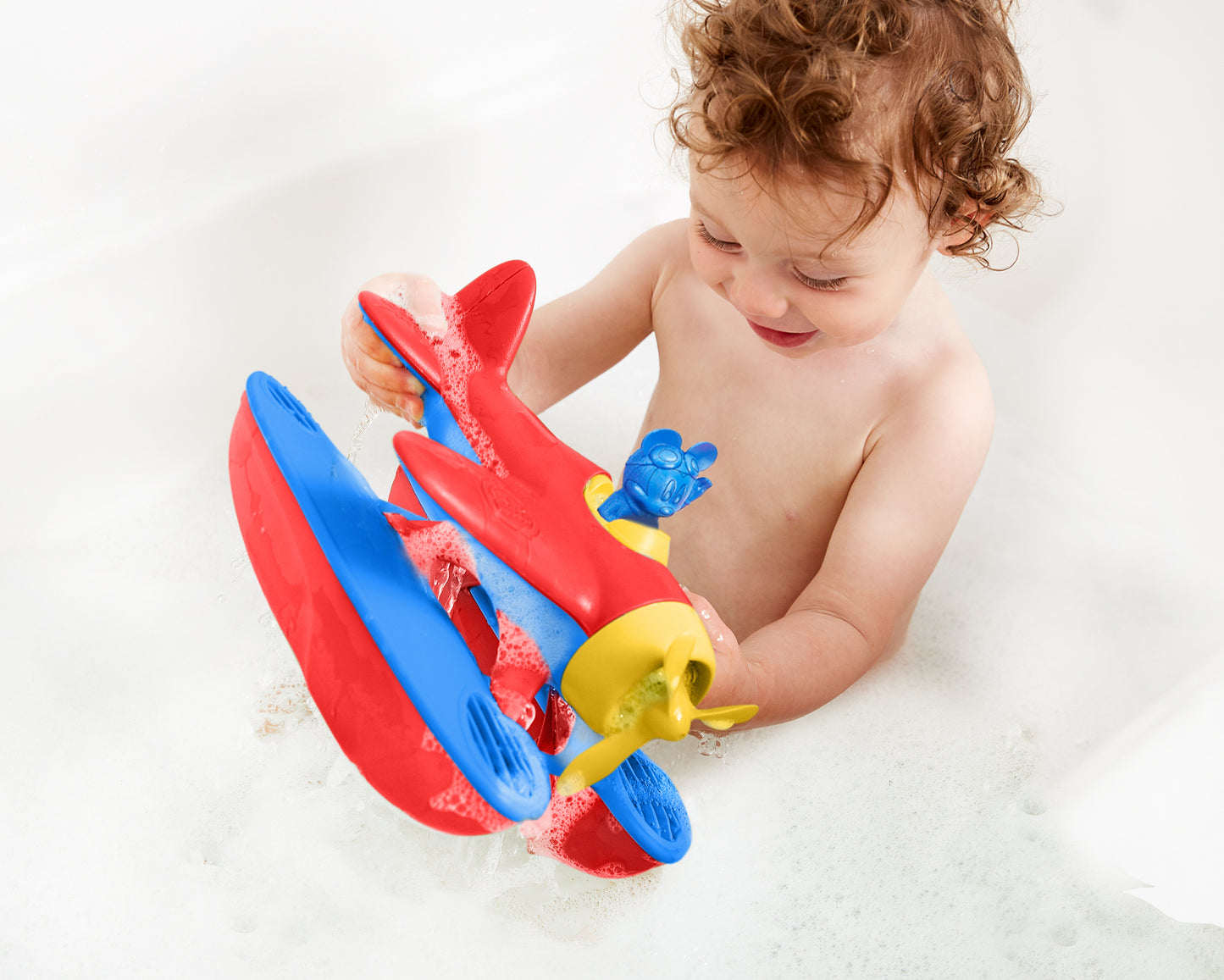 Child in bath playing with Mickey Mouse Seaplane