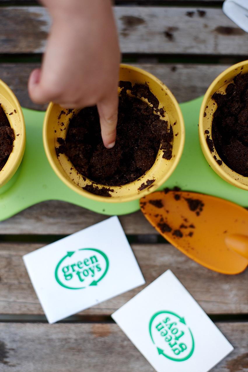 Child's finger in dirt of Indoor Gardening Kit