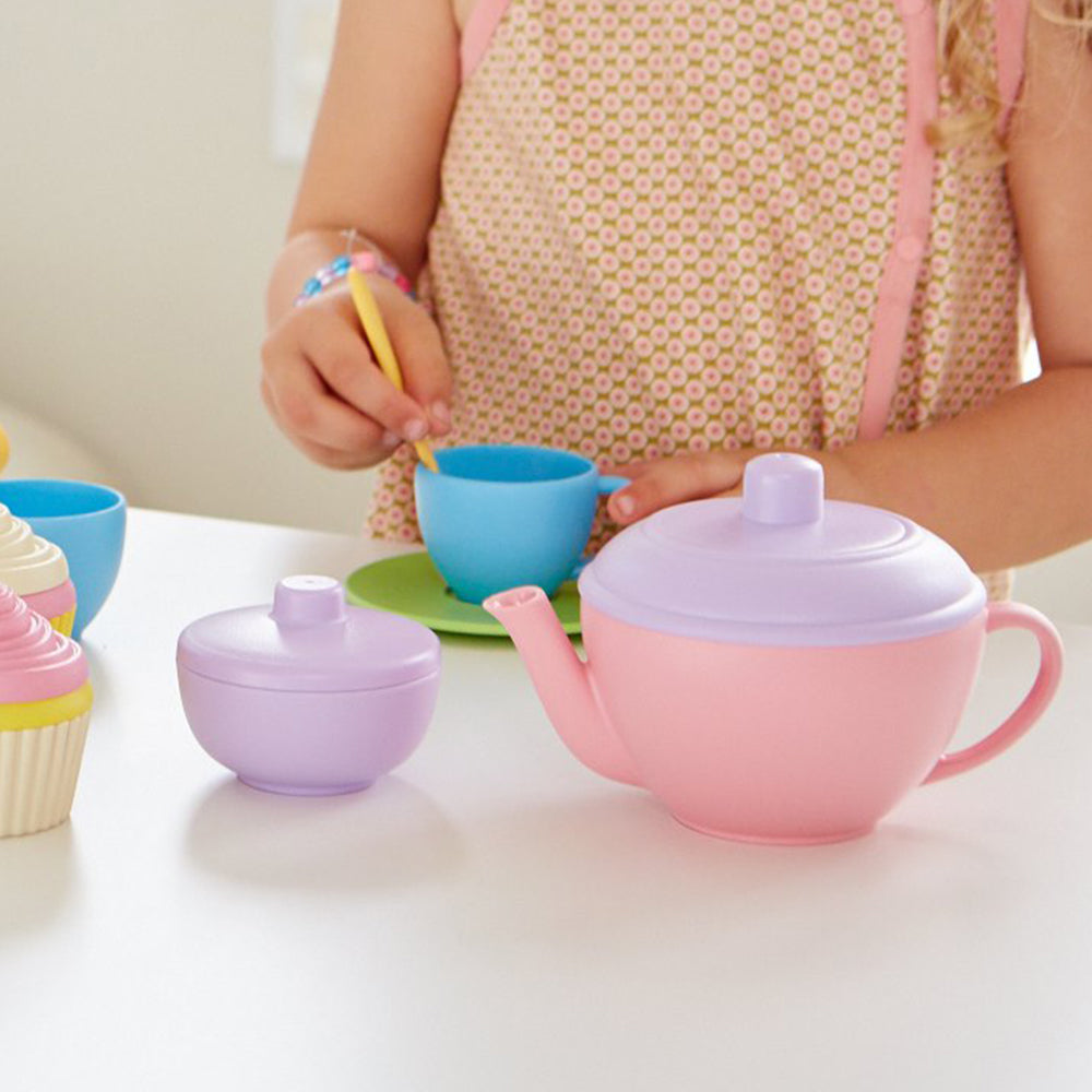 Girl playing with Tea Set