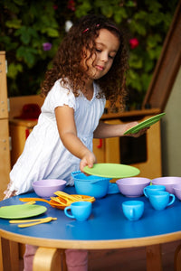 Girl playing with Cookware and Dining Set