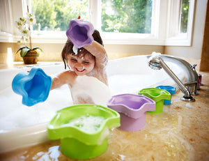 Child in bath playing with Stacking Cups